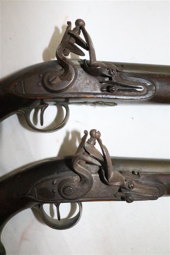 A pair of early 19th century flintlock holster pistols, signed Weston, Lewes, 15in.